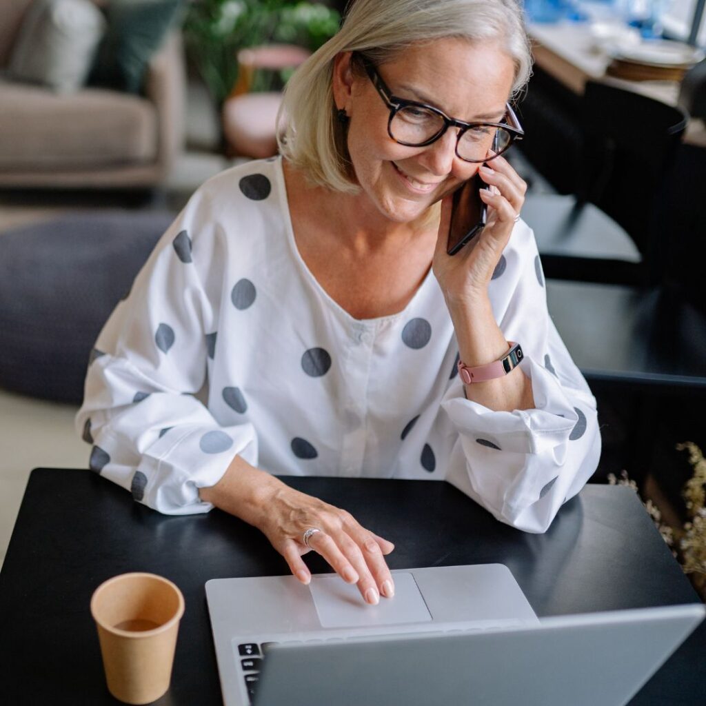 Old woman working and talking on a phone